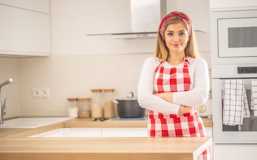 standing in the kitchen with nothing but her apron on