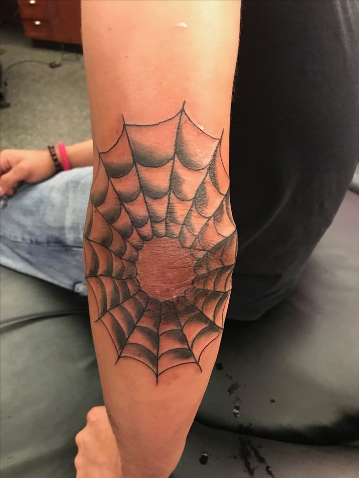 web on elbow tattoo