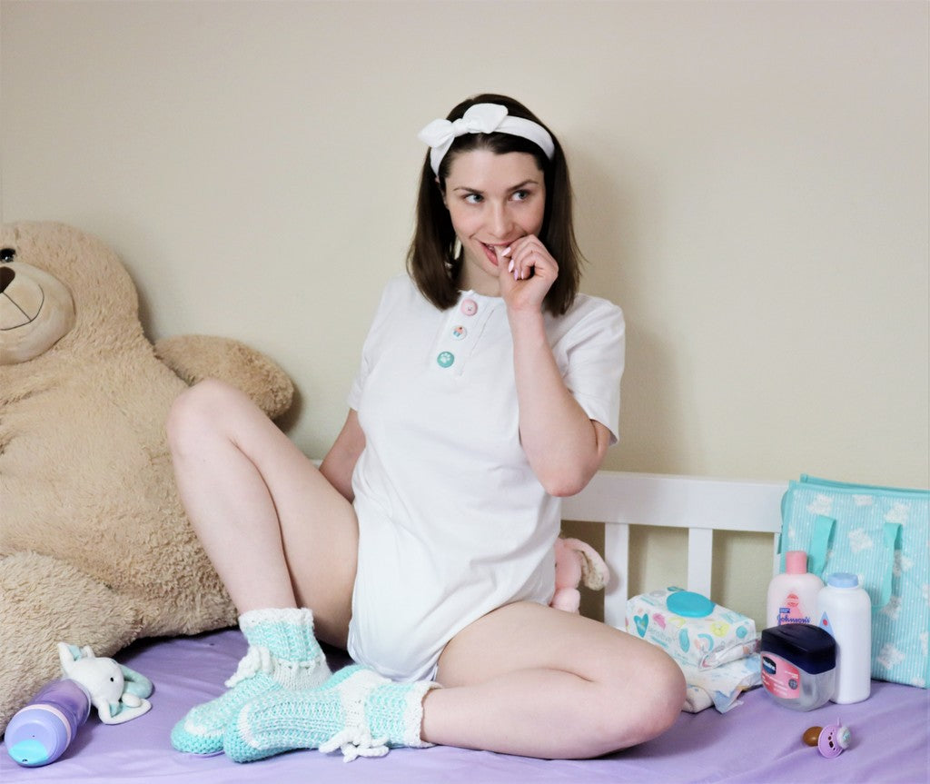 girl in diaper and onesie