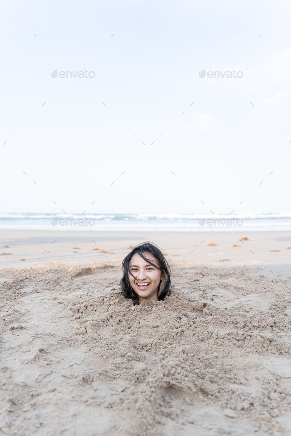 cos share women buried in sand photos